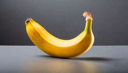 one banana shot on a grey studio background