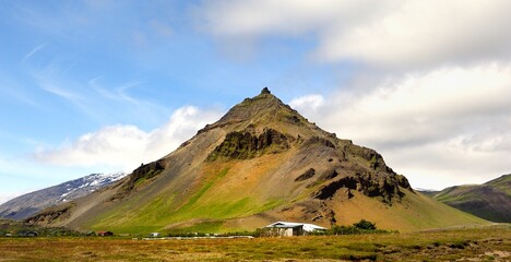 Farm buildings below the  mountain