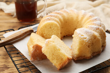 Delicious freshly baked sponge cake on wooden table, closeup