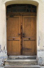 Old weathered, grunge and damaged wooden house entrance door