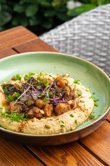 Hummus with warm eggplant in sweet chilli sauce. Healthy vegan food, Israeli cuisine