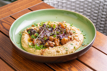 Hummus with warm eggplant in sweet chilli sauce. Healthy vegan food, Israeli cuisine