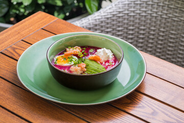 Cold beet soup - traditional cold beetroot soup with avocado, shrimps, yogurt, egg. vegetarian summer dish.