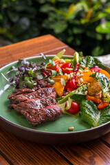 grilled beef steak with vegetables on plate