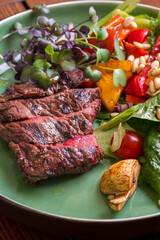 grilled beef steak with vegetables on plate
