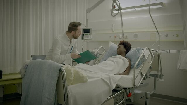 Doctor Visits Patient in Hospital Room Explaining Medical Health Cure Treatment