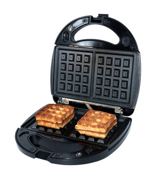 Waffles in an electric waffle iron on a white background. Homemade baking. Waffles
