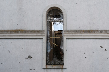 Broken glass of the church window. Shrapnel and bullet marks on the walls (concept: religious...