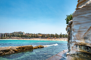 Naklejka premium Coogee Beach, it is Stop 1 on the Bondi to Coogee Walk, with its clear waters, it is a popular beach to swim and surfing, with a deep sweep of sand. Sydney, Australia, Dec 2019