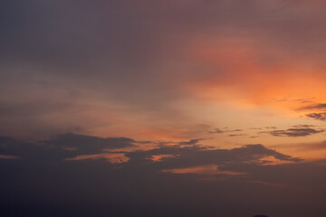 Fototapeta na wymiar Warm foggy sunset sky with pastel romantic clouds, last rays of sun on the horizon before sunset