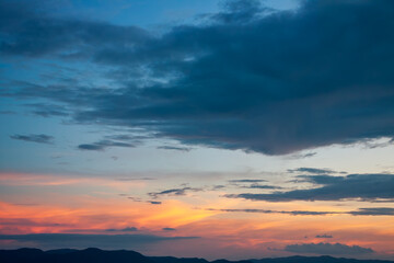 Fototapeta na wymiar Last rays of sun on cinematic colorful contrast sunset sky with nobody on the horizon