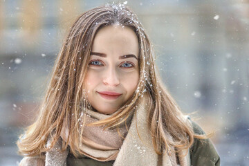 Young beautiful woman posing in a snowy park. Cold weather. Winter fashion, holidays, rest, travel...