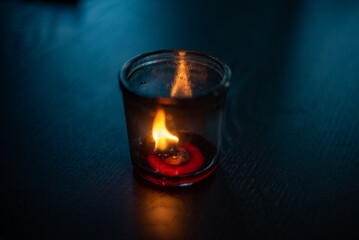 burning candle in the glass