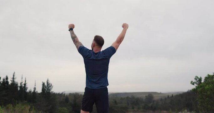 Man, fitness success and running with smart watch in nature for workout goals, achievement and cardio results. Happy sports person or runner with fist, power and yes for exercise timer in forest