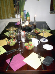 Festively decorated table with dinner, salad, wine, etc. An example of serving a homemade breakfast