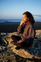 Meditative state of the body, girl meditating in nature high in the mountains, ashtanga yoga,...