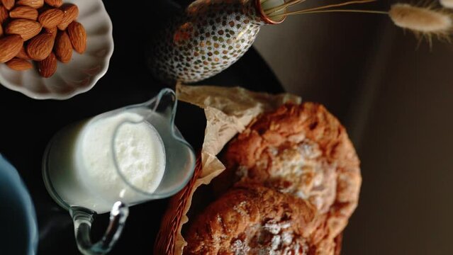 Aesthetic breakfast. Milk coffee, milk tea, sugar, almond, almond cakes, biscuits, marzipans and puffs. British breakfast in a cozy home. Autumn mood. Vertical video.