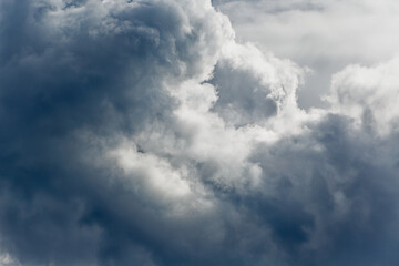 Cumulus clouds in the blue sky close-up view