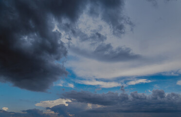 Rain clouds cover a blue sky