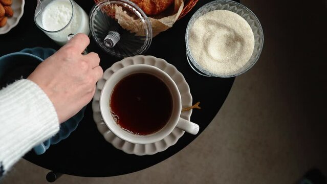 Aesthetic breakfast. Milk coffee, milk tea, sugar, almond, almond cakes, biscuits, marzipans and puffs. British breakfast in a cozy home. Autumn mood.