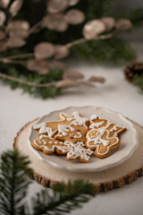 Fototapeta na wymiar Composition with delicious homemade Christmas gingerbread cookies. Festive homemade decorated sweets with Christmas decorations and fir branches.
