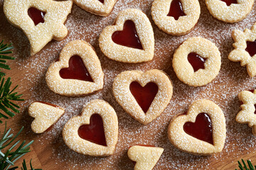 Linzer Christmas cookies in the shape of hearts filled with strawberry marmalade