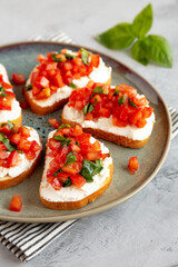 Homemade Tomato Ricotta Tartine on a Plate, side view.