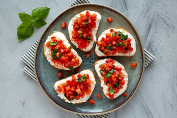 Homemade Tomato Ricotta Tartine on a Plate, top view. Flat lay, overhead, from above.