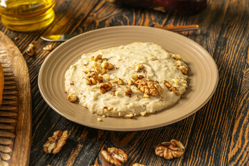 Plate of tasty baba ghanoush on wooden background