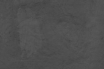 Old stucco plaster surface, brushstroke background, close up grunge texture of black painted...