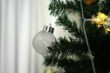 Happy 2024 concept, Christmas ball and lights on Christmas tree.