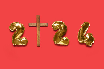 Figure 2024 made of balloons and cross on red background. Concept of Christmas story