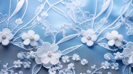 Delicate white floral embroidery on blue fabric with subtle shading