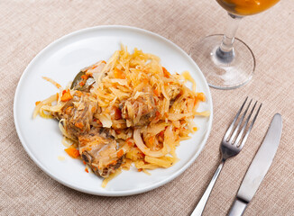 Delicious pork ribs stewed in gravy with sauerkraut closeup