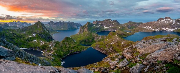 Panorama, view over mountain peaks and sea, with lakes Litlforsvatnet, Tennesvatnet, Krokvatnet and fjord Forsfjorden, dramatic sunset, from Hermannsdalstinden, Moskenesoey, Lofoten, Nordland