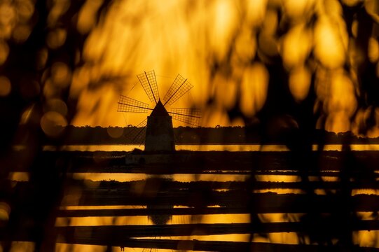 Windmill at sunset, Riserva Naturale Isole dello Stagnone di Marsala, Marsala salt flats, Trapani province, Sicily, Italy, Europe