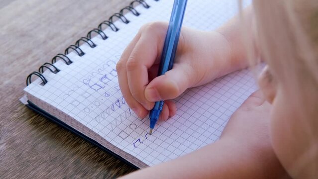 preschool child draws elements with pen in lined notebook, Writing Before School, Developmental Activities for Children, First Steps in Literacy