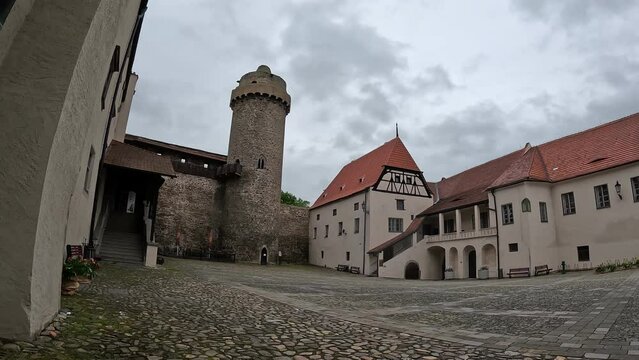 Strakonice castle Panoramic view with its medieval tower under fast-moving clouds in Bohemia, Czech Republic, captured in scenic timelapse.


