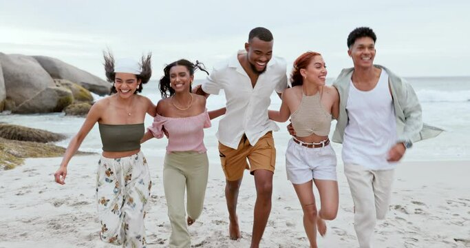 Group, running and friends with vacation, beach and smile with weekend break, bonding or getaway trip. People, men or women with holiday, seaside or summer with journey, freedom or adventure with joy