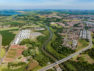 Imagem aérea de casas, ponte e Rio Atibaia que corta a cidade de Paulínia SP (Paulinia) interior...