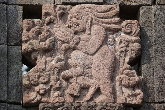 Naked relief on penataran temple wall in Indonesia