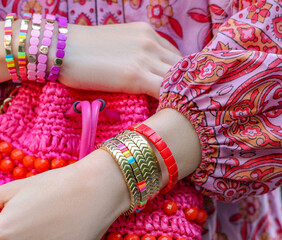 Woman with stylish purse wearing bracelets outdoors, closeup