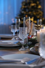 Christmas table setting with festive decor and dishware indoors