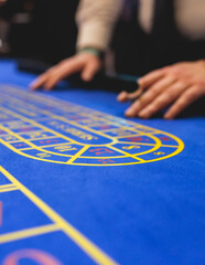 Vibrant casino table with roulette in motion, with casino chips, tokens, the hand of croupier,...