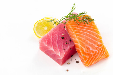 tuna fish fillet steaks and salmon steak with ingredients on white background.