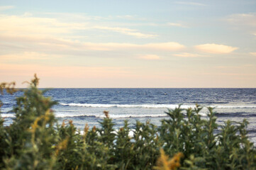 ocean sunset along shoreline 