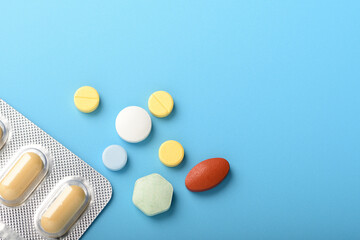 Concept healthcare and medicine. Top view, copy space , Assorted pharmaceutical medicine pills, tablets and capsules. Close up different pills on blue background. Pills background. Free space design.