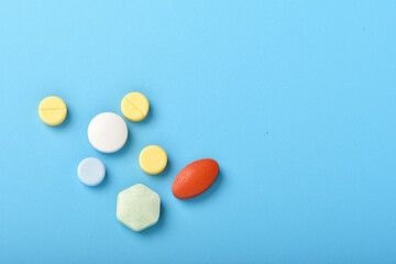 Concept of healthcare and medicine. Top view, copy space , Assorted pharmaceutical medicine pills, tablets and capsules. Close up of many different pills on blue background. Pills background.