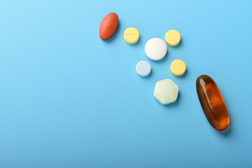 Concept of healthcare and medicine. Top view, copy space , Assorted pharmaceutical medicine pills, tablets and capsules. Close up of many different pills on blue background. Pills background. Free spa