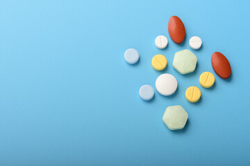 Concept of healthcare and medicine. Top view, copy space , Assorted pharmaceutical medicine pills, tablets and capsules. Close up of many different pills on blue background. Pills background. Free spa